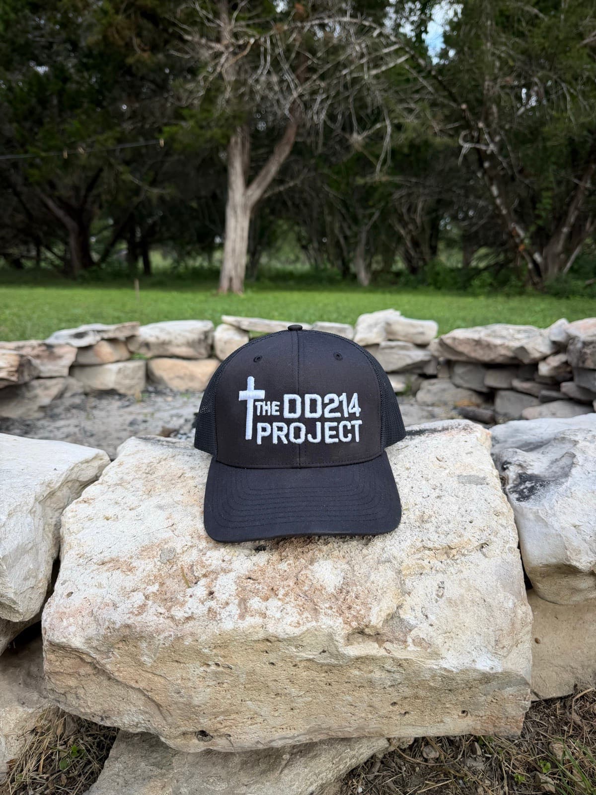 The DD214 Project hat resting on a limestone wall at the ranch